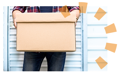 A person holding a cardboard box from cleaning out a storage unit.